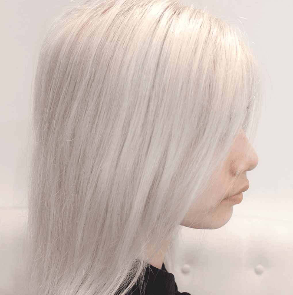 a person with shoulder-length platinum hair