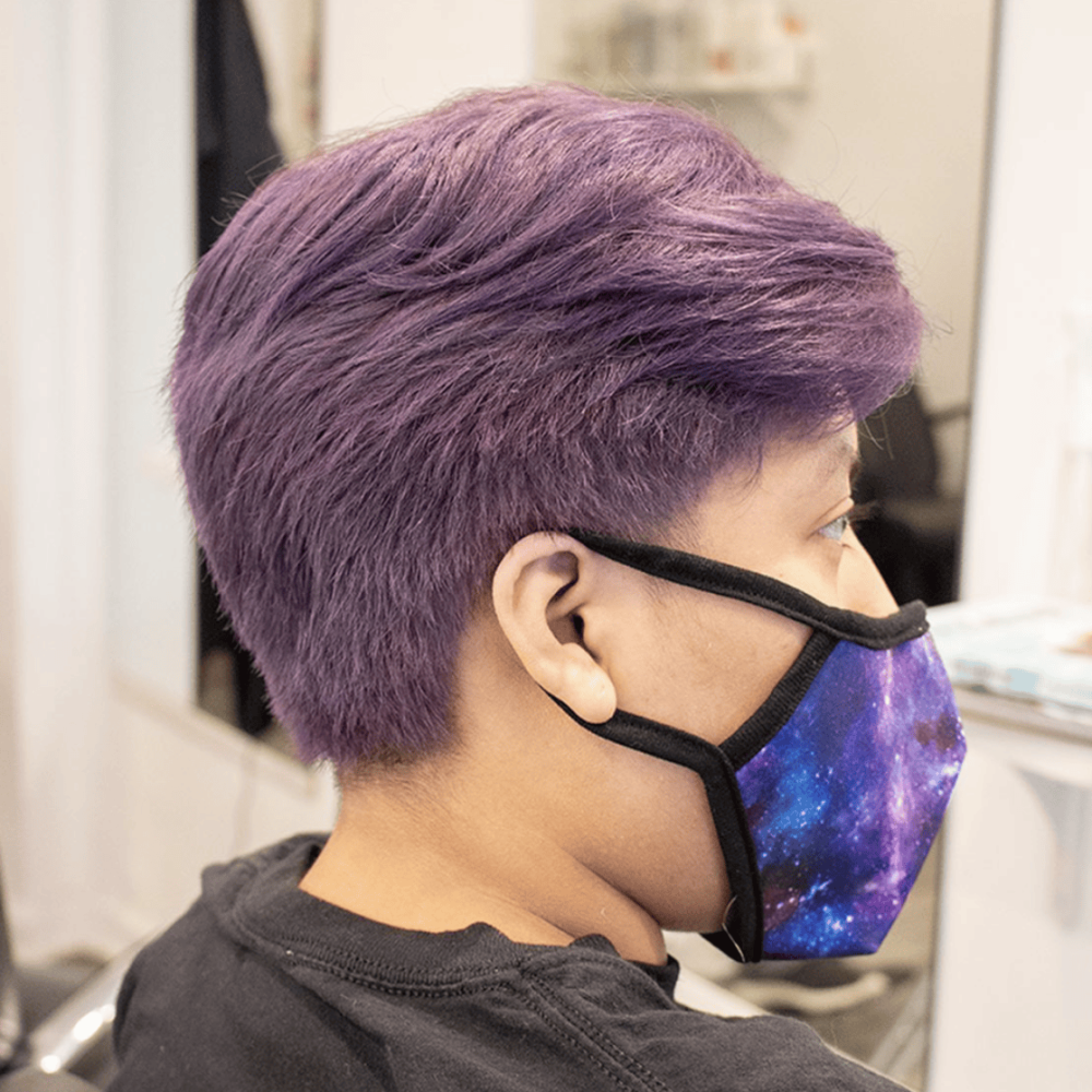 a person with short purple hair doubled processed